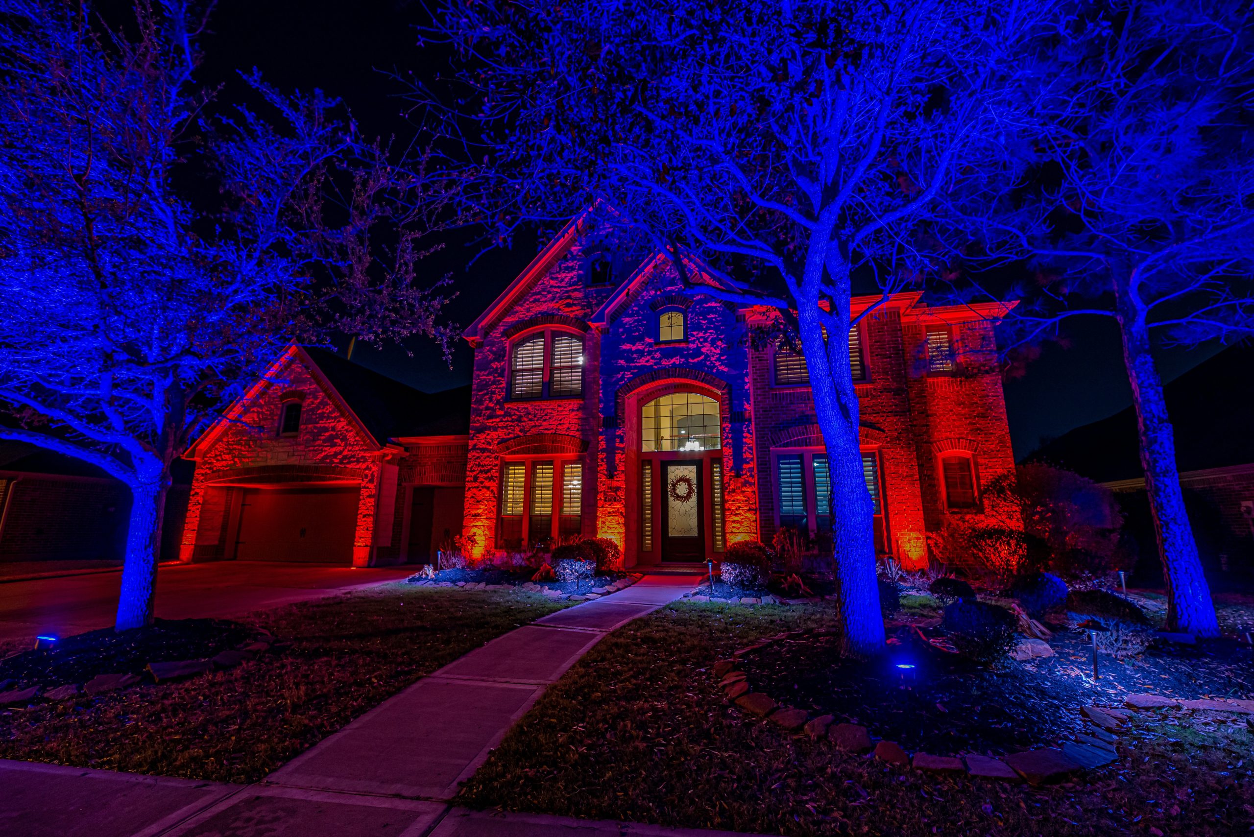 Vibrant red and blue LED lighting on Houston home facade